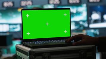 Army telecommunication systems operator using green screen gear, providing combat support. Military dispatcher managing communications networks with mockup laptop, camera A video