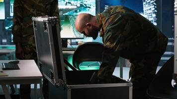 Army soldiers in command center packing weapons able to engage targets at extended range. Military units reloading gun cartridge, preparing for enemy assault mission, camera A video