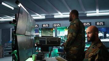 Military officer using tracking software on laptop to gain info helpful against enemies. Army professional using notebook to gain intel helping troops, coordinating mission activities, camera B video