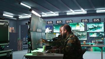 Terrorist threatening soldiers with rifles in command post. Insurgent using guns to control hostages during enemy base assault hijacking in guerilla warfare armed conflict, camera B video