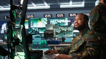 Soldiers working in governmental facility, doing surveillance with digital radar equipment, operating missile systems. Man monitoring army HQ CCTV for any unauthorized activity, camera B video