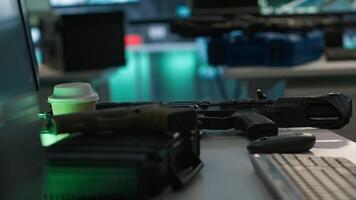 Weapons on table in secure room in army governmental facility operating as military command post and surveillance monitoring center. Extreme close up of guns in empty military base of operations video