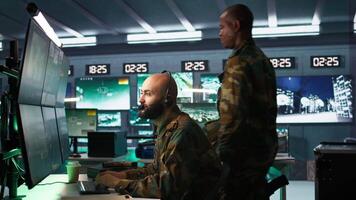 Soldier solving tasks in military HQ base, gathering information on enemy troops. Middle Eastern agent in base of operations doing assessment of enemy vulnerabilities, tracking, camera B video