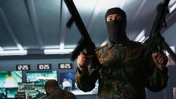 Terrorist wearing mask holding rifles, prepared to start guerilla warfare operation against enemies. Rebel forces insurgent with weapon in hidden base starting offensive against opponents, camera B video