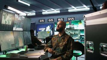 Military agent using augmented reality tech in control room, analyzing aerial reconnaissance data. Intelligence corps expert controlling drones attacking strategic targets using AR hologram, camera B video