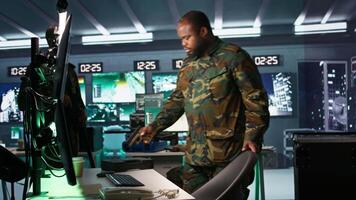 Intelligence corps expert in military HQ base gathering information on enemy troops. Officer arriving at work in base of operations, starting assessment of enemy vulnerabilities, tracking, camera B video