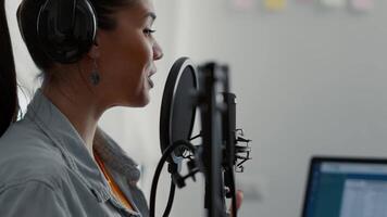 Smiling influencer broadcasting internet talk show while speaking to public. Popular social media content creator talking to public on microphone while streaming podcast. video