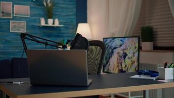Empty podcast room with professional microphone in vlogger home studio in living. Influencer recording social media content with production microphone, digital web internet streaming station video