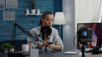 Tech influencer reviewing modern wireless mouse while presenting it to audience. Famous social media star doing recommendation for electronic device while sitting at home studio desk. video