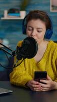 Vertical . Influencer using laptop while talking with followers during live on social media. Creative online show On-air production internet broadcast host streaming live content, recording digital vlog video