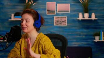 Famous young woman recording a vlog for subscribers using podcast microphone for vlogging. On-air online production internet broadcast show host streaming live content for social media video