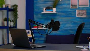 Online live podcast studio desk with microphone in home studio of vlogger. Influencer recording social media content with production microphone. Digital web internet streaming station video