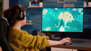 Professional esport woman gamer looking at camera smiling while compete in videogame playing space shooter game. Online streaming cyber performing on powerful personal computer during gaming tournament video