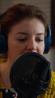 Vertical . Close up of blogger talking on podcast microphone during streaming, new vlog series. On-air online production internet broadcast show host live content, recording digital social media communication video