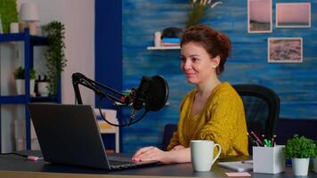 Portrait of caucasian vlogger working in cozy studio, smiling at camera ready to start new podcast show. On-air online production internet broadcast show host streaming web content record digital blog video