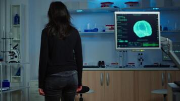 Wired patient waiting scientist doctor in neurological research laboratory visiting scientists examining tomography scan. Woman sitting in lab equipped for development of experiments video