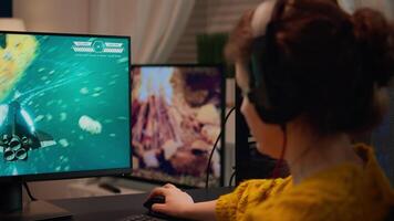 Gamer playing game on championship discussing with teammates using mic of headset. Pro-gamner performing on powerful computer in stylish room during esport gaming tournament video