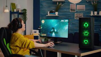 Joyful gamer celebrates victory winning shooter online game on powerful personal computer. Online streaming cyber performing during gaming tournament using technology network wireless video