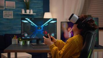 Professional gamer wearing virtual reality headset using wireless controller. Pro esport team player streamer playing gaming tournament on powerful RGB computer, using modern streaming technology video