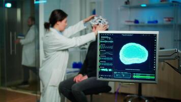 Medical researcher in neurological medicine preparing patient for examining brain functions using high tech and neurology tools for scientific research in technologically advanced lab office video