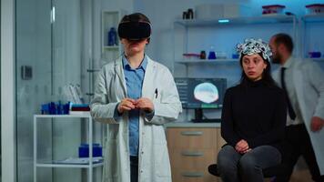 Laboratory doctor experiencing virtual reality using vr goggles in medical neurological research lab. Physician therapist using medical innovation equipment device glasses, analysing brain scan. video