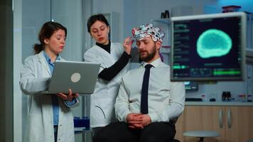 Women team neurological researchers working together developing treatment for diagnosis of braindisease, explaning eeg results, health status, brain functions, nervous system and tomography scan video