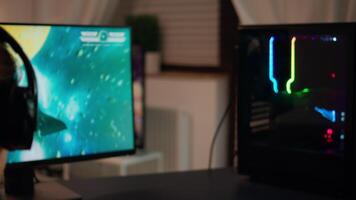 Back view shot of professional gamer playing in first-person shooter online game on computer. Virtual championship in cyberspace, esports player performing on pc during gaming tournament. video