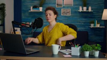 Portrait of young vlogger working in cozy studio, smiling at camera ready to start new podcast show. On-air online production internet broadcast show host streaming web content record digital blog video