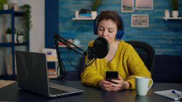 Influencer using laptop while talking with followers during live on social media. Creative online show On-air production internet broadcast host streaming live content, recording digital vlog video