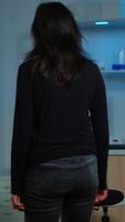 Vertical . Wired patient waiting scientist doctor in neurological research laboratory visiting scientists examining tomography scan. Woman sitting in lab equipped for development of experiments video