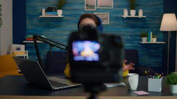 Blogger speaking about life during podcast in home studio looking at camera. Online show On-air production internet broadcast host streaming live content, recording digital social media communication video