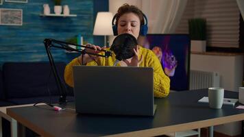 Vlogger looking at laptop and asking audience to subscribe on her channel. Online show On-air production internet broadcast host streaming live content, recording digital social media communication video