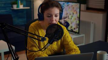 Vlogger looking at laptop while asking audience to subscribe on her channel. Creative online show On-air production internet broadcast host streaming live content, recording digital social media communication video