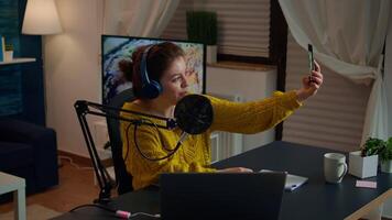 Entertainment blogger doing selfie during broadcast working from home studio. On-air online production internet podcast show host streaming live content, recording digital social media communication video
