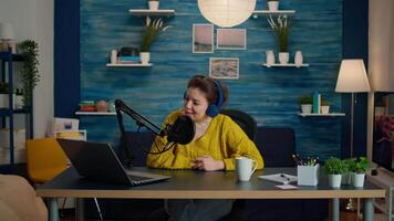 Famous vlogger kissing followers at camera from home studio durinng podcast. On-air online production internet broadcast show host streaming live content, recording digital social media communication video