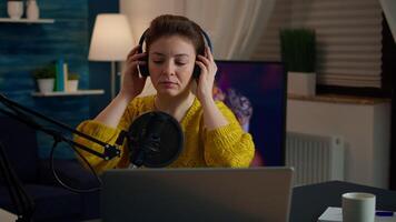 Famous blogger streaming from home studio putting headphones recording vlog. On-air online production internet broadcast show host streaming live content record digital social media communication video