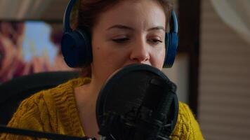 Close up of blogger talking on podcast microphone during streaming, new vlog series. On-air online production internet broadcast show host live content, recording digital social media communication video