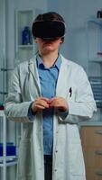 Vertical . Laboratory doctor experiencing virtual reality using vr goggles in medical neurological research lab. Physician therapist using medical innovation equipment device glasses, analysing brain scan video