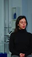 Vertical . Asistance of neurological doctor putting eeg headset on patient head scaning brain functions, descovering diagnosis of disease. Team of scientists researchers working late night in neurology clinic video