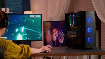 Gamer trying to win space shooter game playing on professional computer from home during egame comptition. Virtual shooter game in cyberspace, esports player performing on pc gaming tournament video