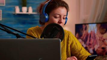 Vlogger messaging with online audience while recording podcast in home studio for social media. Creative online show On-air production internet broadcast host streaming live content for social media video