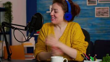 Influencer making online internet content for web subscribers in home podcast studio during livestreaming. On-air online production internet broadcast show host streaming live content for social media video