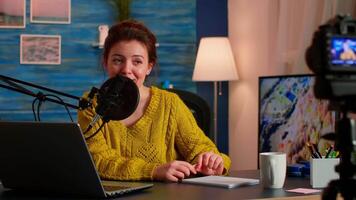 Blogger influencer recording blog concept speaking looking at camera on tripod in home podcast studio. Social media vlogger shooting vlog, streaming online broadcast using internet web video