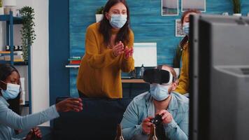 Diverse friends trying to win playing games experiencing virtual reality headset having fun enjoying beer and popcorn wearing face mask to prevent spreading virus in time of global outbreak video