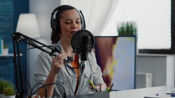 Young content creator starting internet live podcast talk show. Popular social media influencer getting ready to broadcast remote interview while sitting at desk with professional audio equipment. video