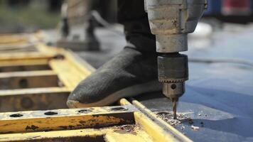 A worker at a construction site drills a hole video