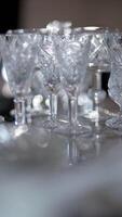 Crystal Glassware in a Row on the Table with Sparkling Bokeh video