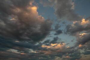 Cloudscape, Colored Clouds at Sunset near the Ocean in a Cloudy Day photo
