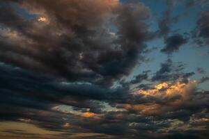 Cloudscape, Colored Clouds at Sunset near the Ocean in a Cloudy Day photo