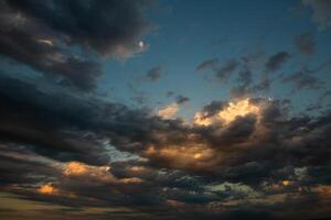 Cloudscape, Colored Clouds at Sunset near the Ocean in a Cloudy Day photo